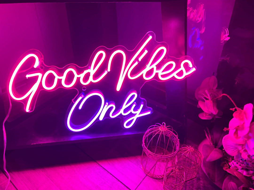 Vibrant Good Vibes Only wedding neon sign by ManhattanNeons.com, glowing in the romantic atmosphere.