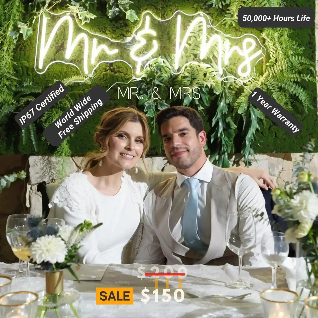 a cute couple sits in front of our Mr & Mrs wedding neon sign from ManhattanNeons.com.